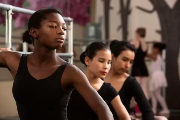 Three young ballerinas in formation.